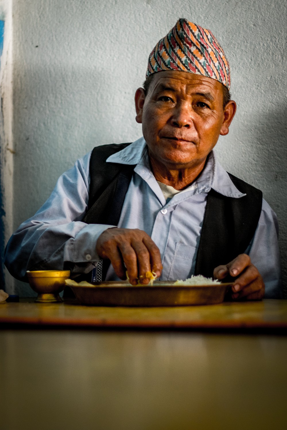 A man lunches on dhal bhat, Nepal